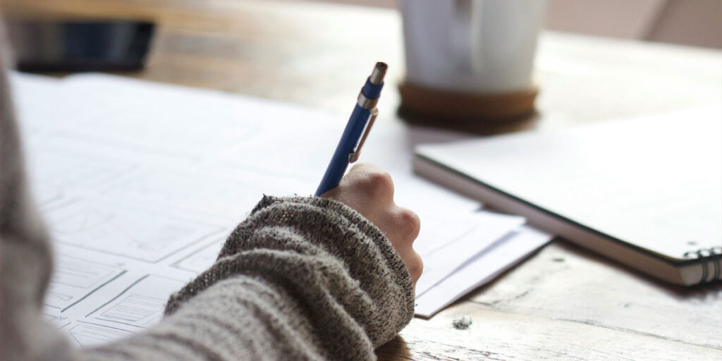 Person taking notes on some paper